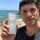A 3x3 collage of people holding and using CV brand electrolyte drink cans in various real-world settings, including outdoors with mountains and ocean views, at home, and working or relaxing.